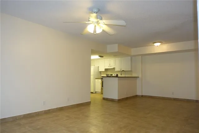 a kitchen with granite countertop white cabinets and white appliances
