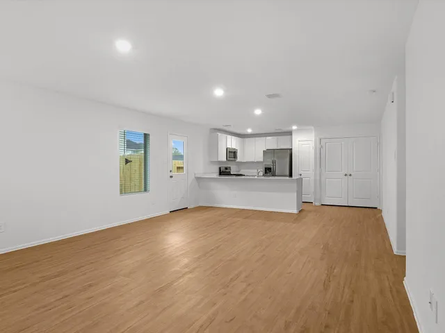 a view of a kitchen with a sink and a window