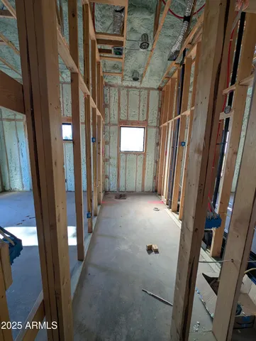 a view of a hallway with wooden floor and entryway