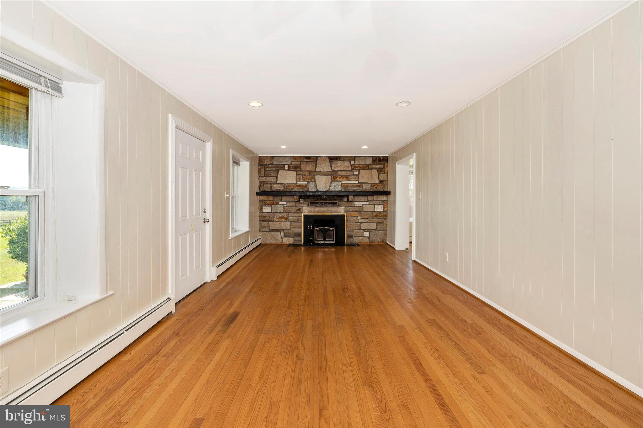 1021 Saffell Road Reisterstown, MD 21136 - Photo 27 of 57 a view of empty room with wooden floor and fireplace