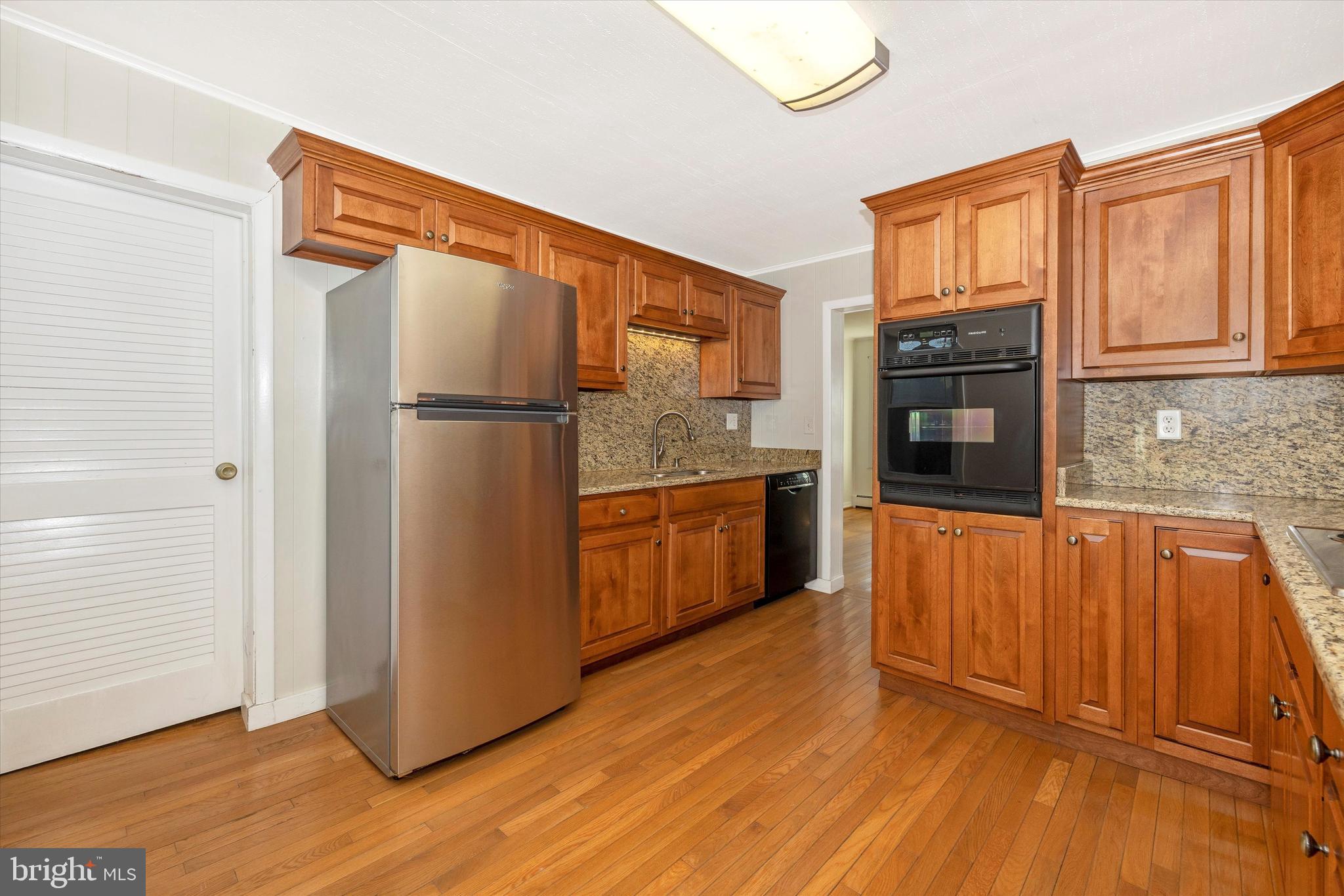 1021 Saffell Road Reisterstown, MD 21136 - Photo 39 of 57 a kitchen with stainless steel appliances granite countertop a refrigerator and a stove top oven