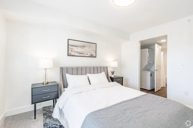 a bedroom with a bed and a night stand