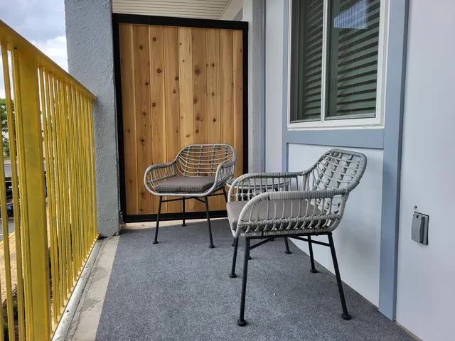 a view of a balcony with chair and table