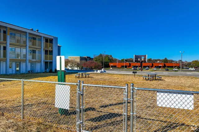 a view of swimming pool with outdoor seating and city view