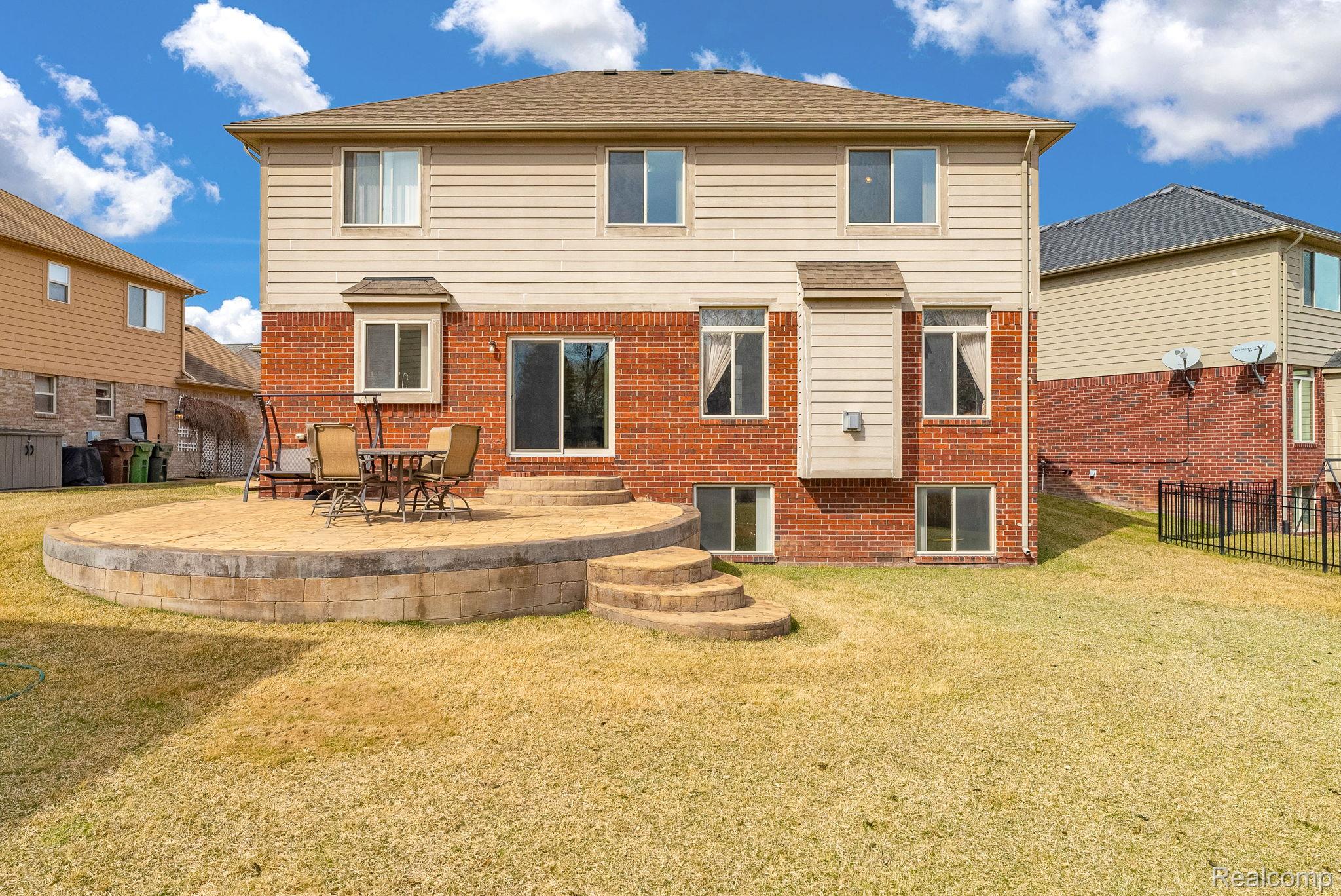 4122 Hawks Nest Road Utica, MI 48317 - Photo 63 of 74 Back of property featuring brick siding and a patio area