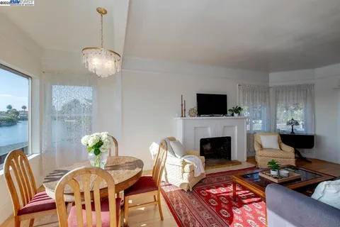 a dining room with furniture and a lake view