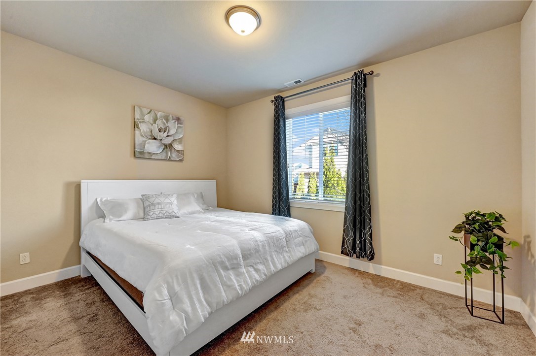 3228 170th Place Southeast Bothell, WA 98012 - Photo 13 of 40 a bedroom with a bed and a potted plant