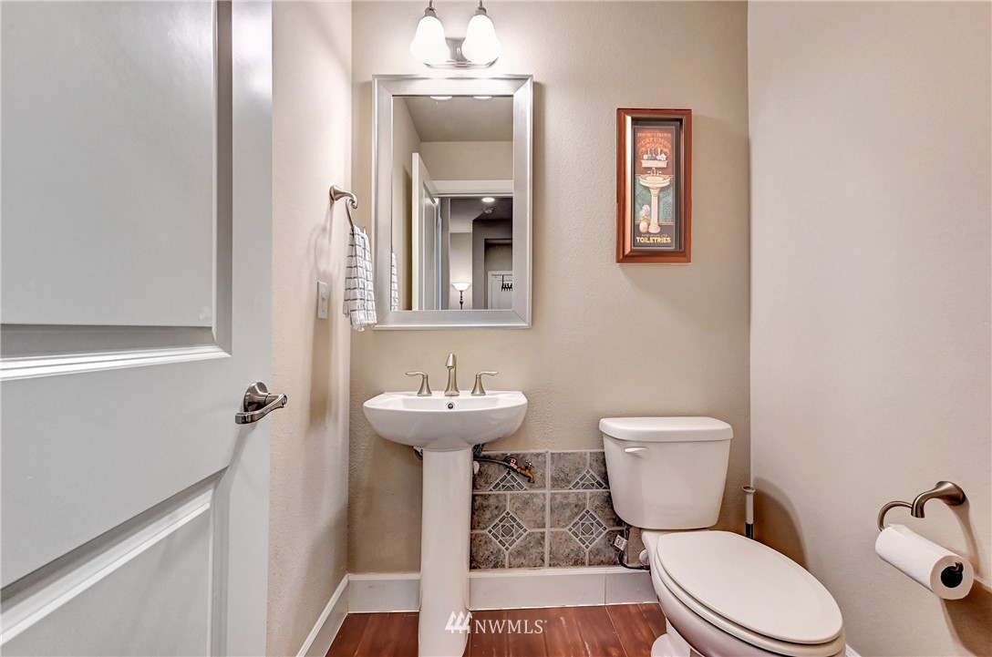 3228 170th Place Southeast Bothell, WA 98012 - Photo 14 of 40 a white toilet sitting next to a bathroom sink