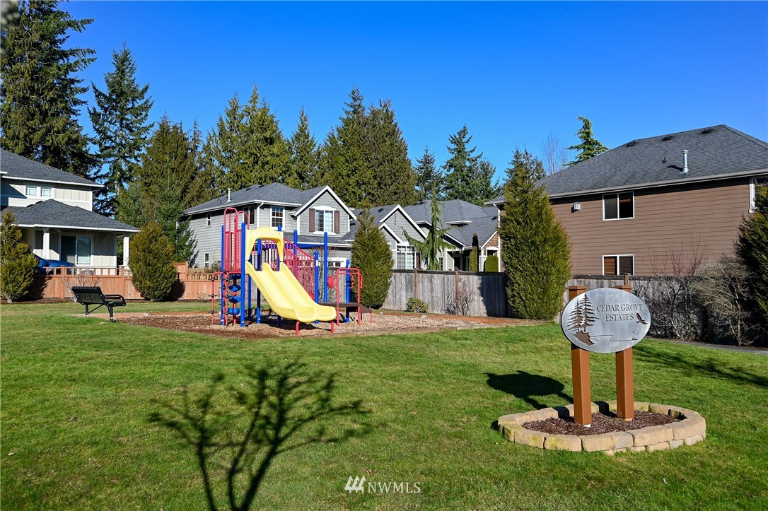 3228 170th Place Southeast Bothell, WA 98012 - Photo 19 of 40 a view of a house with backyard water fountain and sitting area