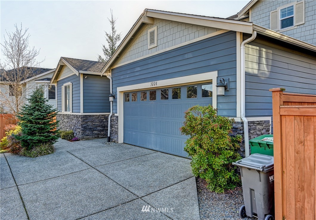 3228 170th Place Southeast Bothell, WA 98012 - Photo 2 of 40 a front view of a house with garden