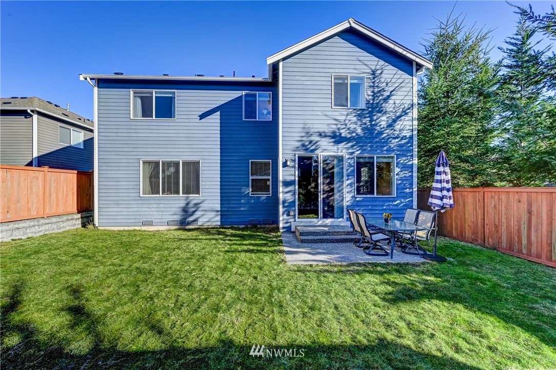 3228 170th Place Southeast Bothell, WA 98012 - Photo 21 of 40 a front view of a house with garden and chairs