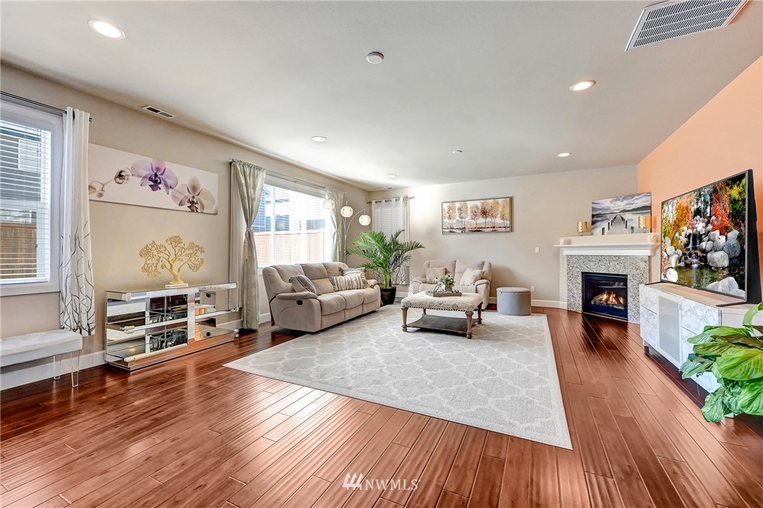 3228 170th Place Southeast Bothell, WA 98012 - Photo 23 of 40 a living room with furniture a fireplace and a flat screen tv