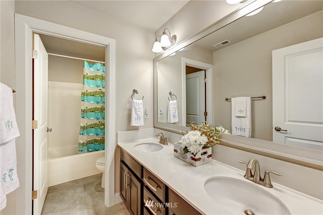 3228 170th Place Southeast Bothell, WA 98012 - Photo 25 of 40 a bathroom with a granite countertop sink and a mirror