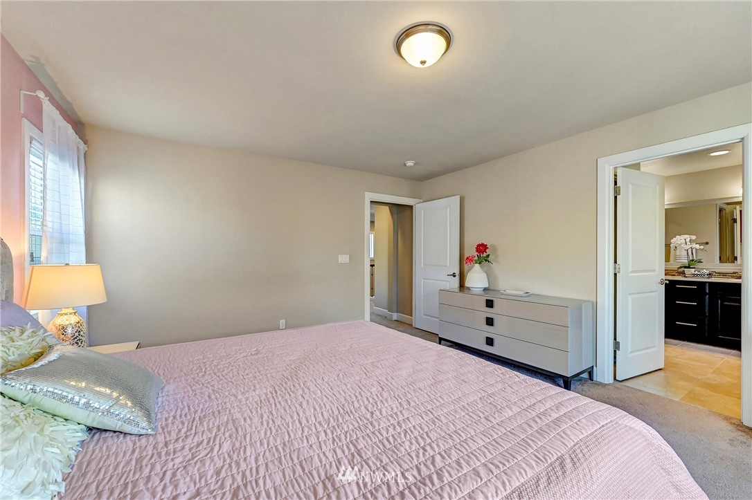 3228 170th Place Southeast Bothell, WA 98012 - Photo 27 of 40 a bedroom with a bed and a chandelier