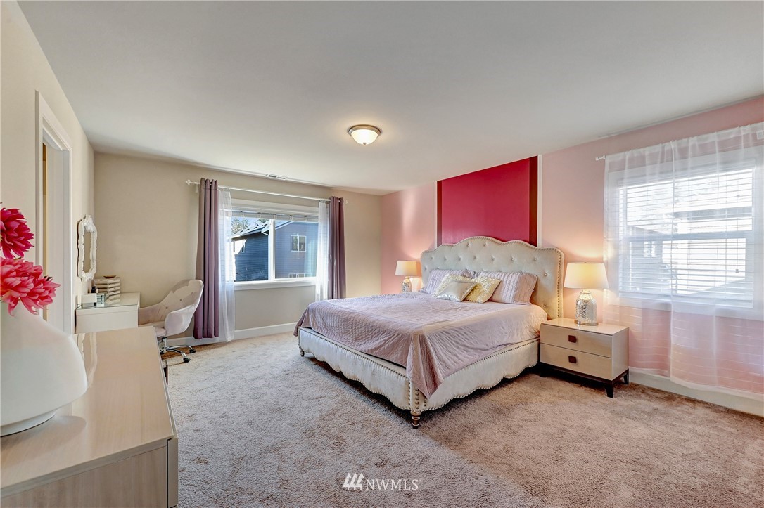 3228 170th Place Southeast Bothell, WA 98012 - Photo 28 of 40 a bedroom with a bed and large windows