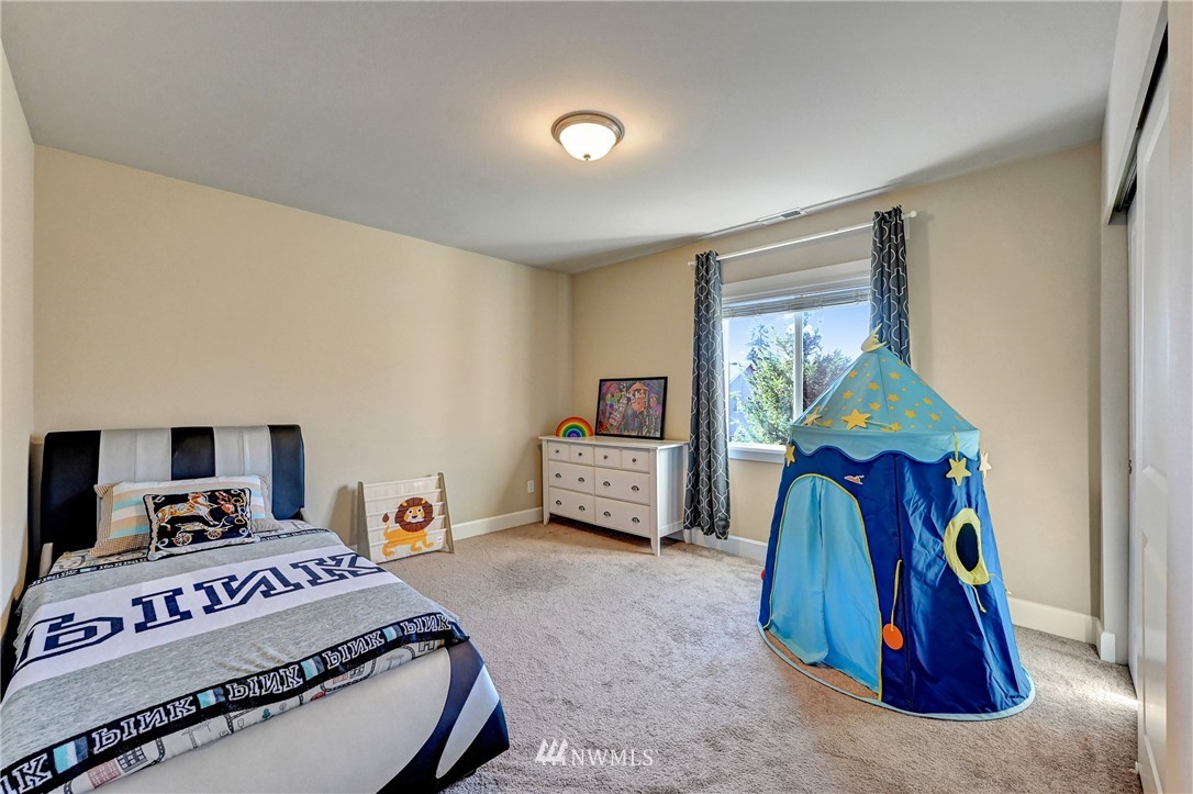 3228 170th Place Southeast Bothell, WA 98012 - Photo 29 of 40 a bedroom with a bed and a painting on the wall