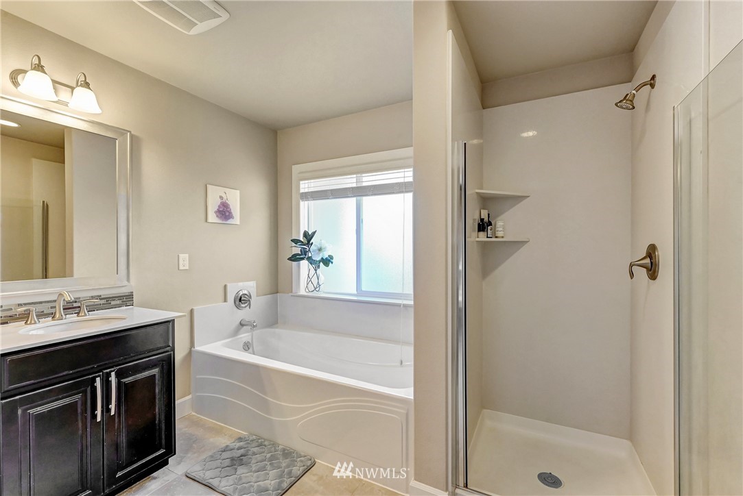 3228 170th Place Southeast Bothell, WA 98012 - Photo 32 of 40 a bathroom with a bathtub a shower a sink and a sink