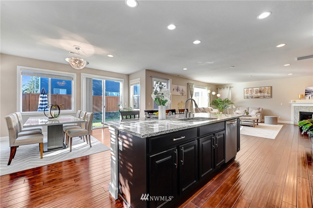3228 170th Place Southeast Bothell, WA 98012 - Photo 5 of 40 a large kitchen with lots of counter space dining table and chairs