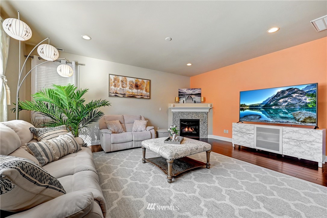 3228 170th Place Southeast Bothell, WA 98012 - Photo 10 of 40 a living room with furniture and a fireplace