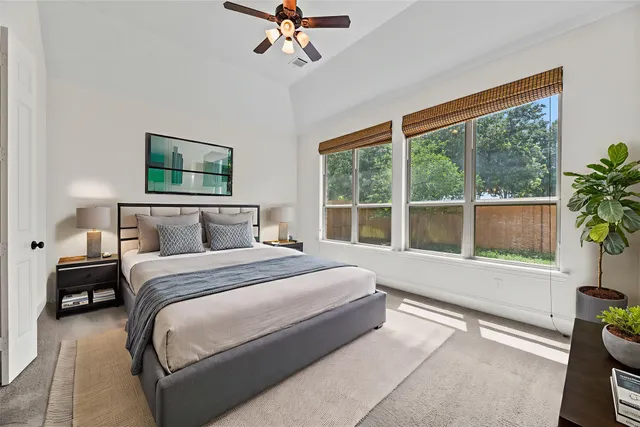 a spacious bedroom with a large bed and a window