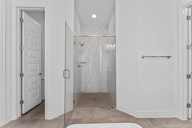 a bathroom with a shower and a sink