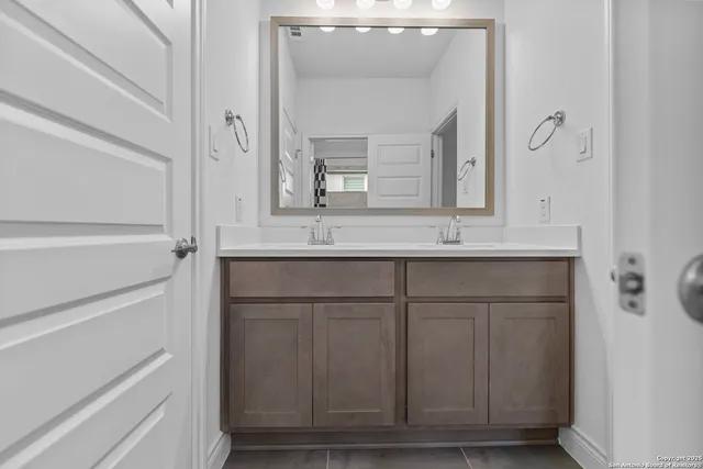 a bathroom with a sink and a mirror