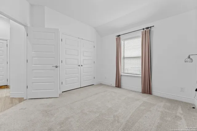 an empty room with closet area