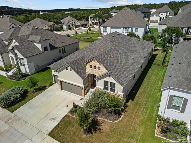 an aerial view of multiple houses with a yard