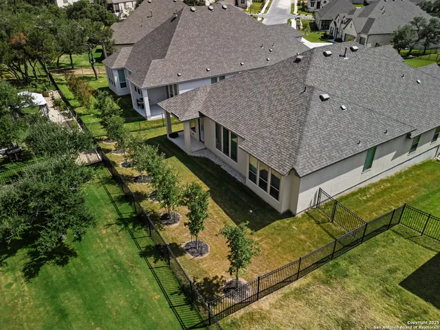 an aerial view of residential house with outdoor space and seating