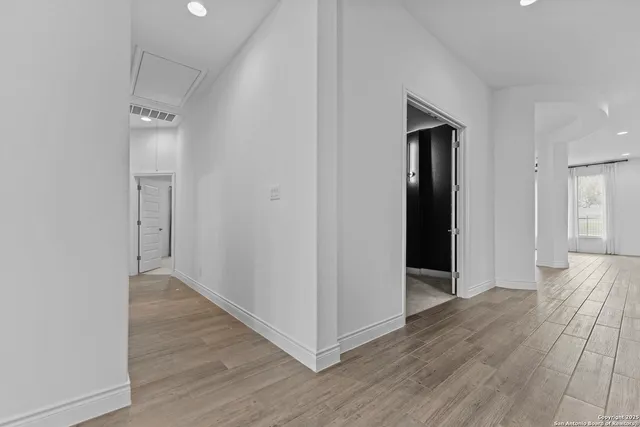 a view of hallway with wooden floor