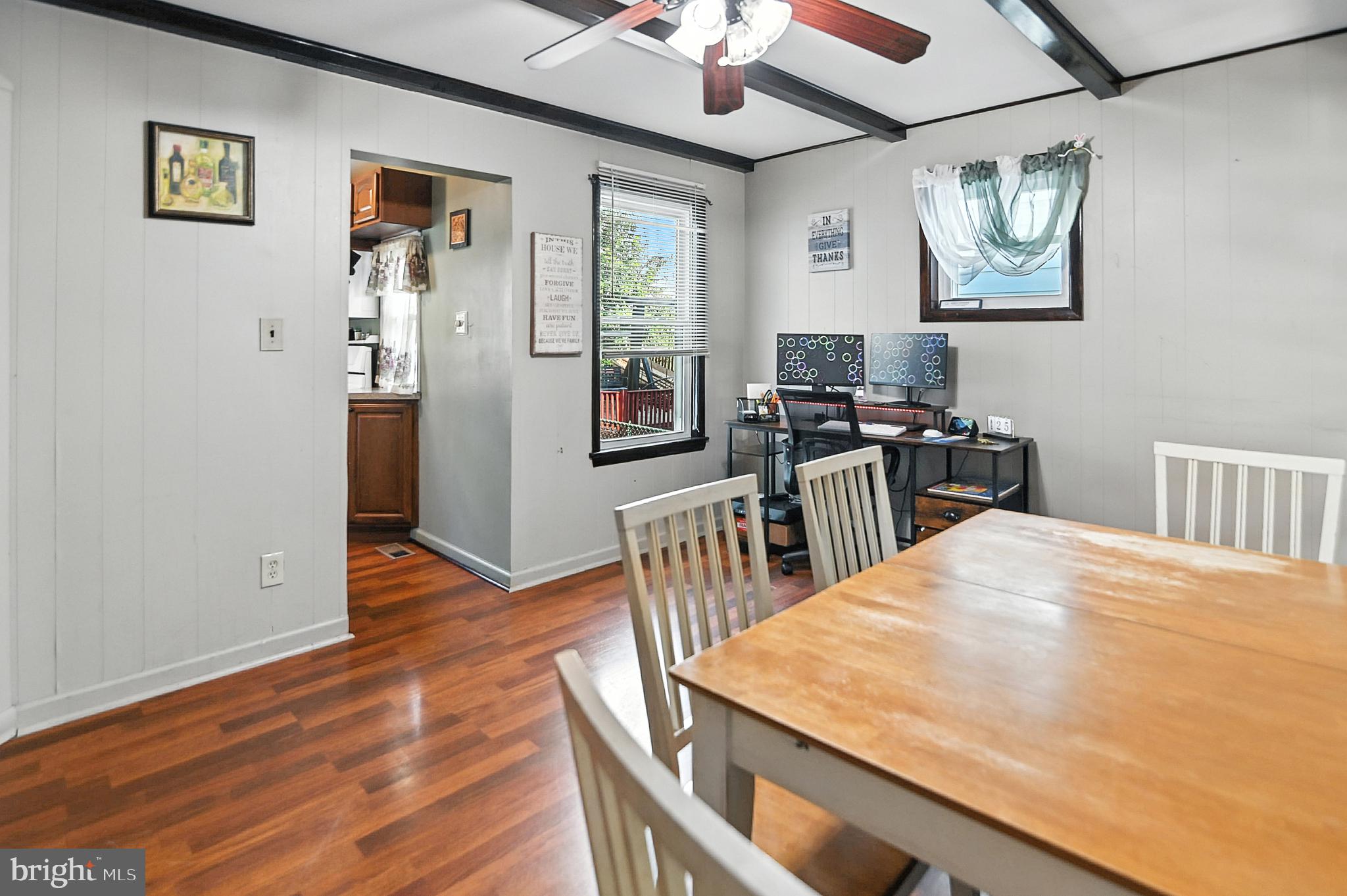 215 Haakon Road Brooklawn, NJ 08030 - Photo 3 of 20 a kitchen with a table chairs and wooden floor