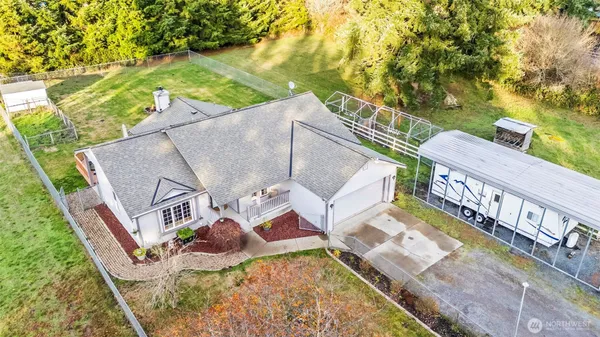 an aerial view of residential house with outdoor space and trees