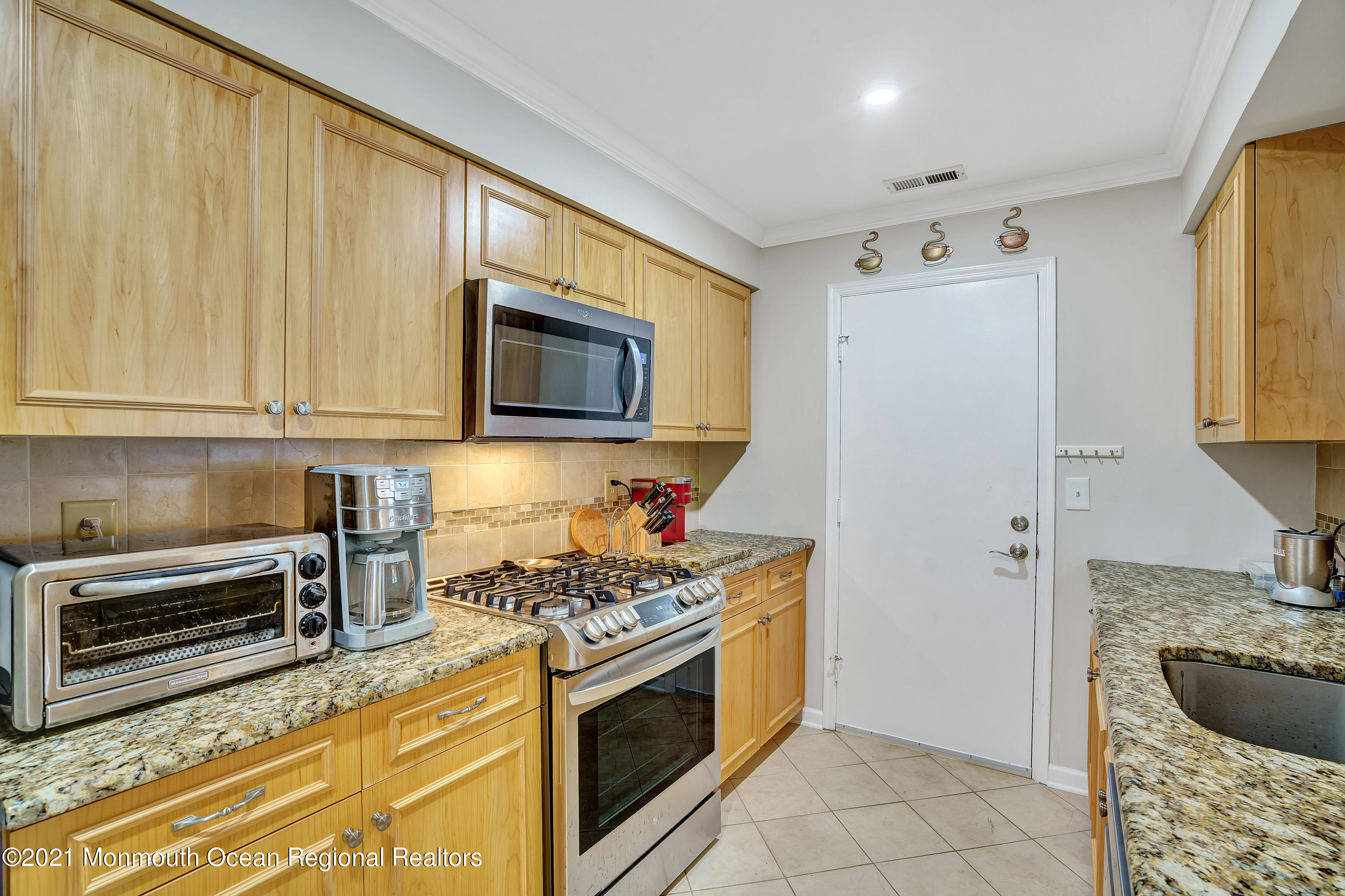 7 Racquet Road Wall, NJ 07719 - Photo 14 of 28 a kitchen with stainless steel appliances granite countertop a stove microwave and refrigerator