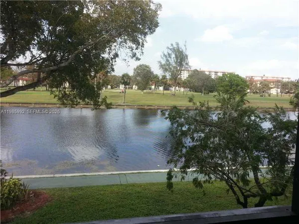 a view of lake with a yard