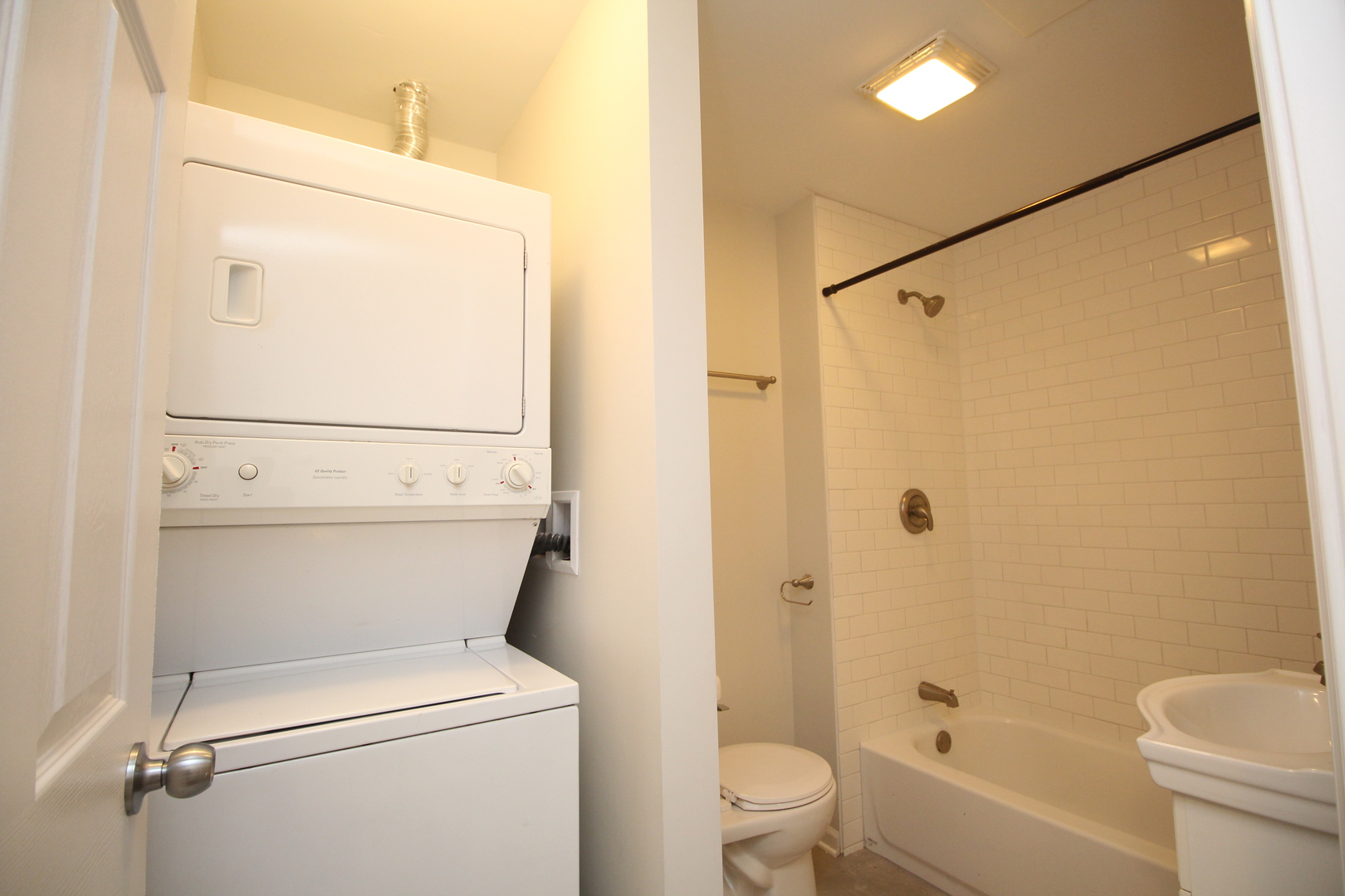 120 North Spring Street, Unit 1 Elgin, IL 60120 - Photo 12 of 12 a white toilet sitting next to a bathroom sink