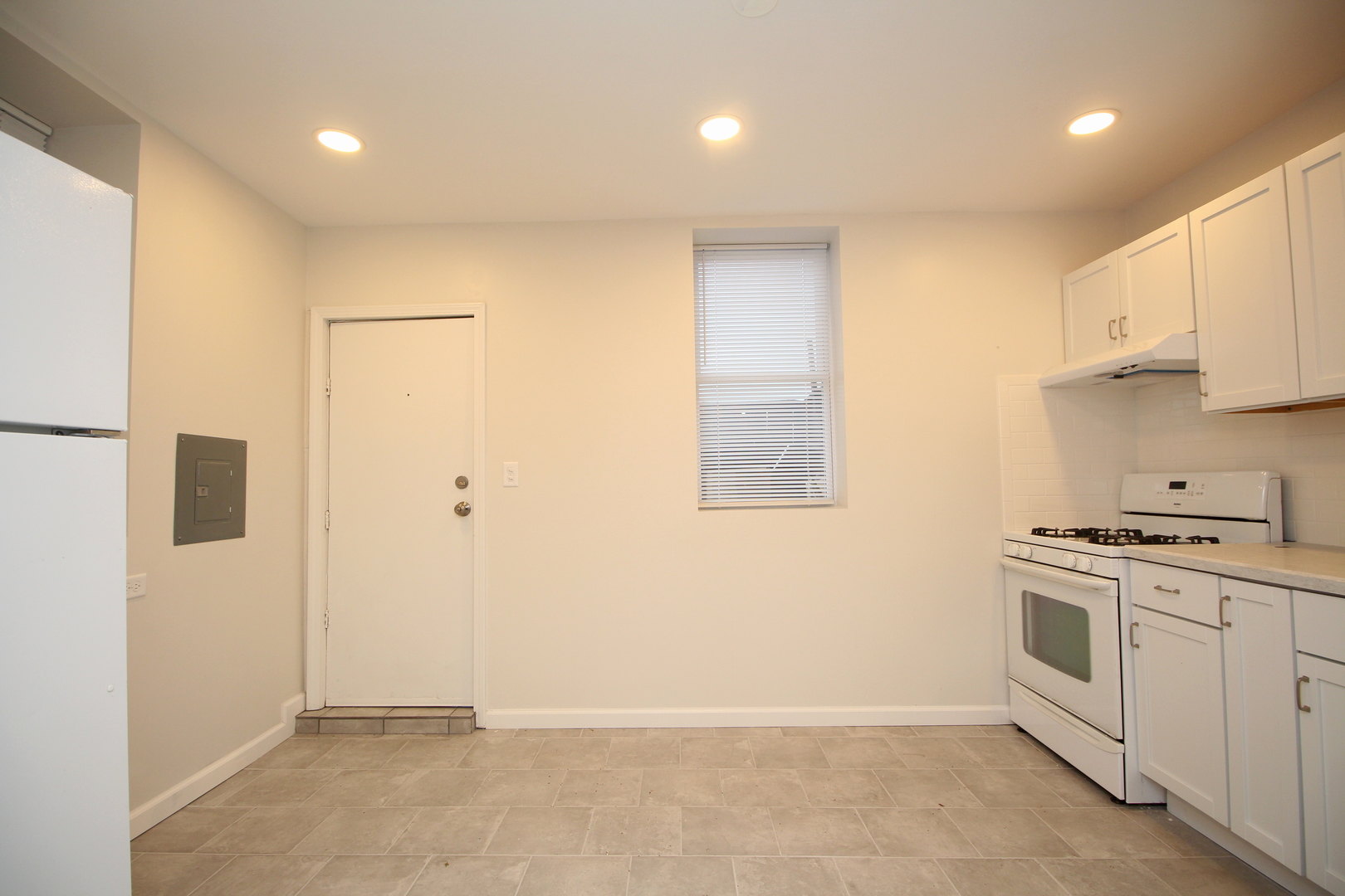 120 North Spring Street, Unit 1 Elgin, IL 60120 - Photo 3 of 12 a view of a kitchen with electric appliances