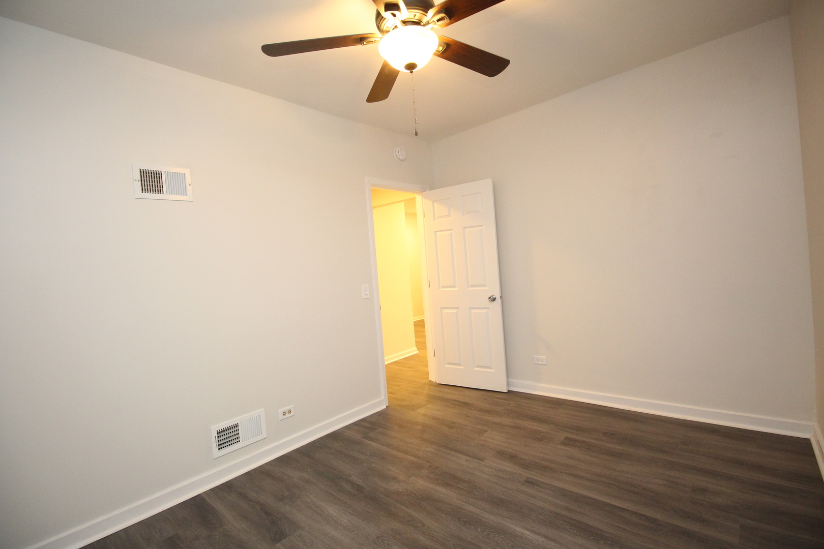 120 North Spring Street, Unit 1 Elgin, IL 60120 - Photo 10 of 12 an empty room with wooden floor and windows