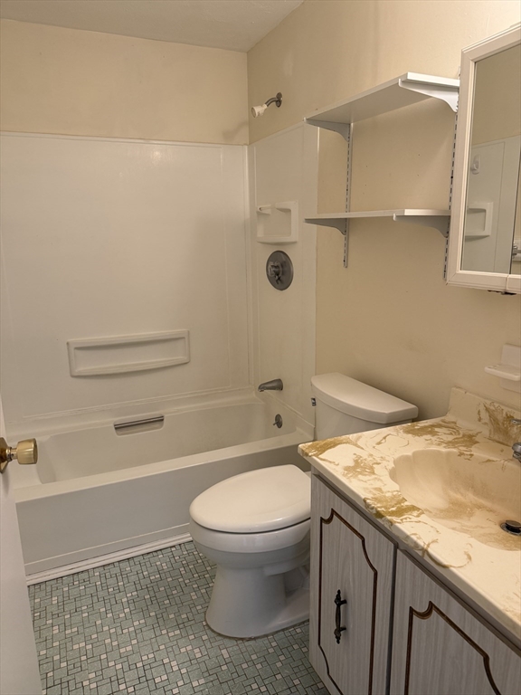310 Codman Hill Road, Unit 34D Boxborough, MA 01719 - Photo 10 of 17 a bathroom with a granite countertop toilet a sink and shower