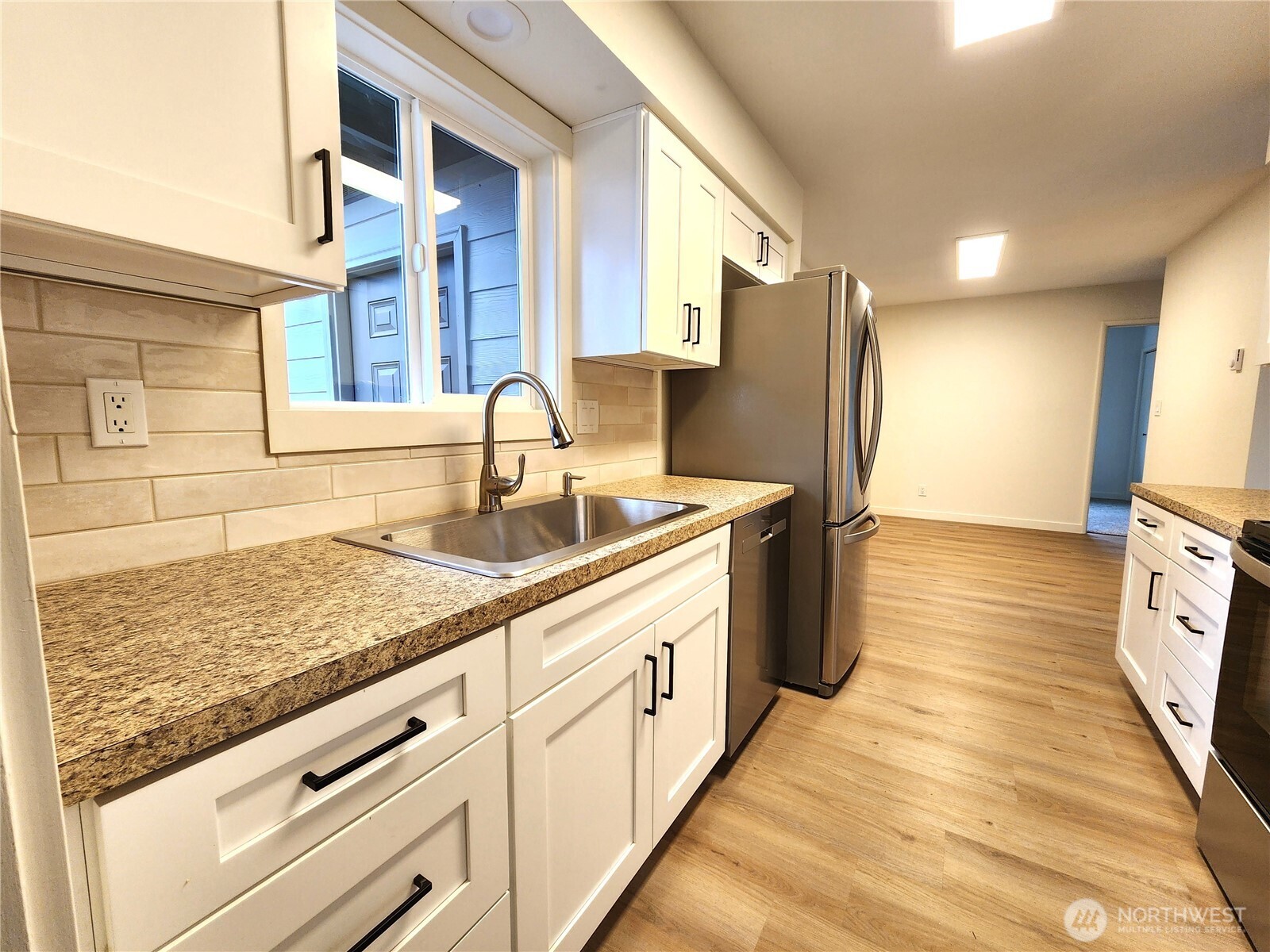 103 Kraft Road Longview, WA 98632 - Photo 8 of 19 a kitchen with stainless steel appliances granite countertop a sink stove and refrigerator