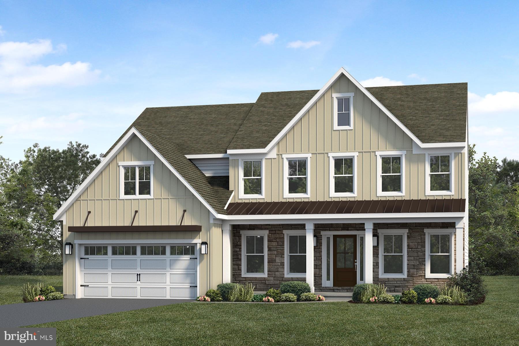 a front view of a house with a garden and yard