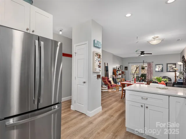 a view of a kitchen center island cabinets and wooden floor