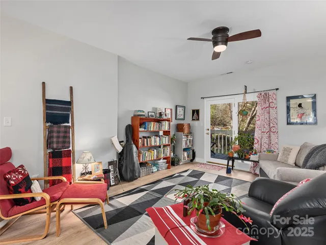 a living room with furniture and a book shelf
