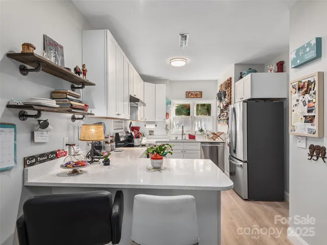 a kitchen with refrigerator and cabinets
