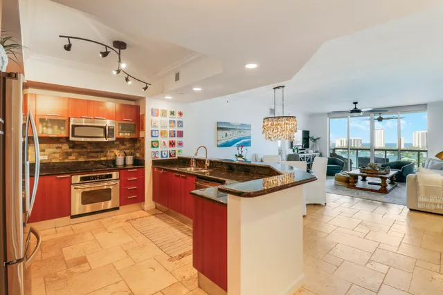 a kitchen with stainless steel appliances granite countertop a stove oven and a refrigerator