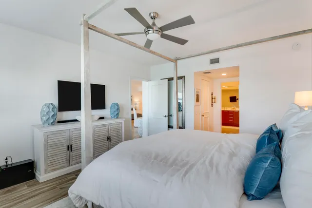 a bedroom with a bed and a flat screen tv