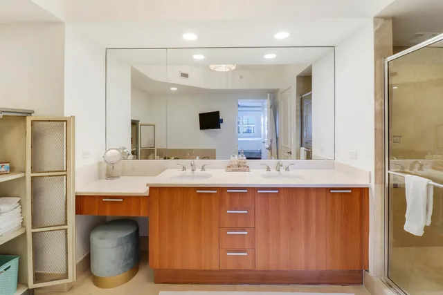 a bathroom with a sink double vanity and a mirror