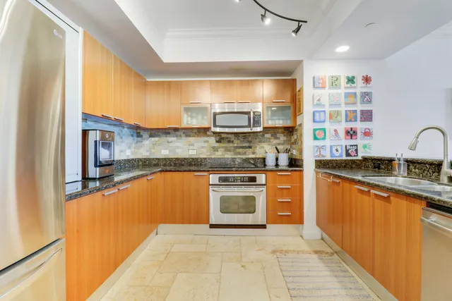 a kitchen with stainless steel appliances granite countertop a sink and cabinets