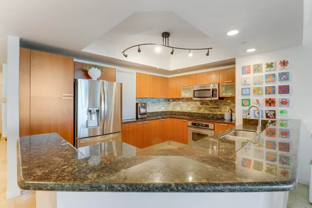 a kitchen with stainless steel appliances granite countertop a sink and cabinets