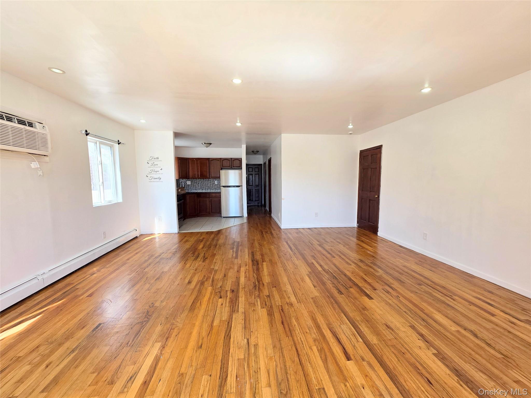 219-23 114th Road Queens, NY 11411 - Photo 3 of 9 a view of empty room with wooden floor