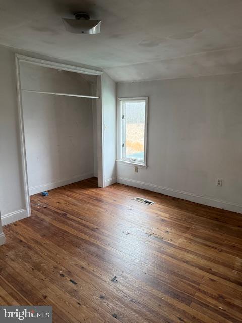 21365 Canoe Neck Way Abell, MD 20606 - Photo 13 of 23 an empty room with wooden floor and windows
